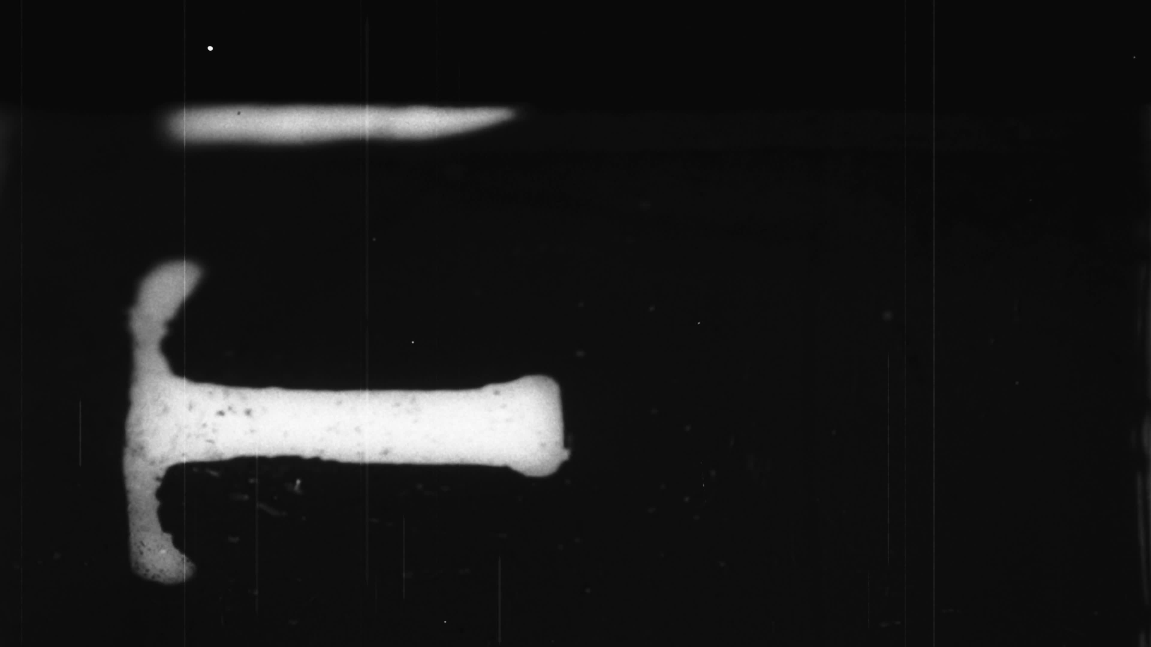 Grainy vintage 16mm film leader countdown with textured noise and retro cinematography effect.