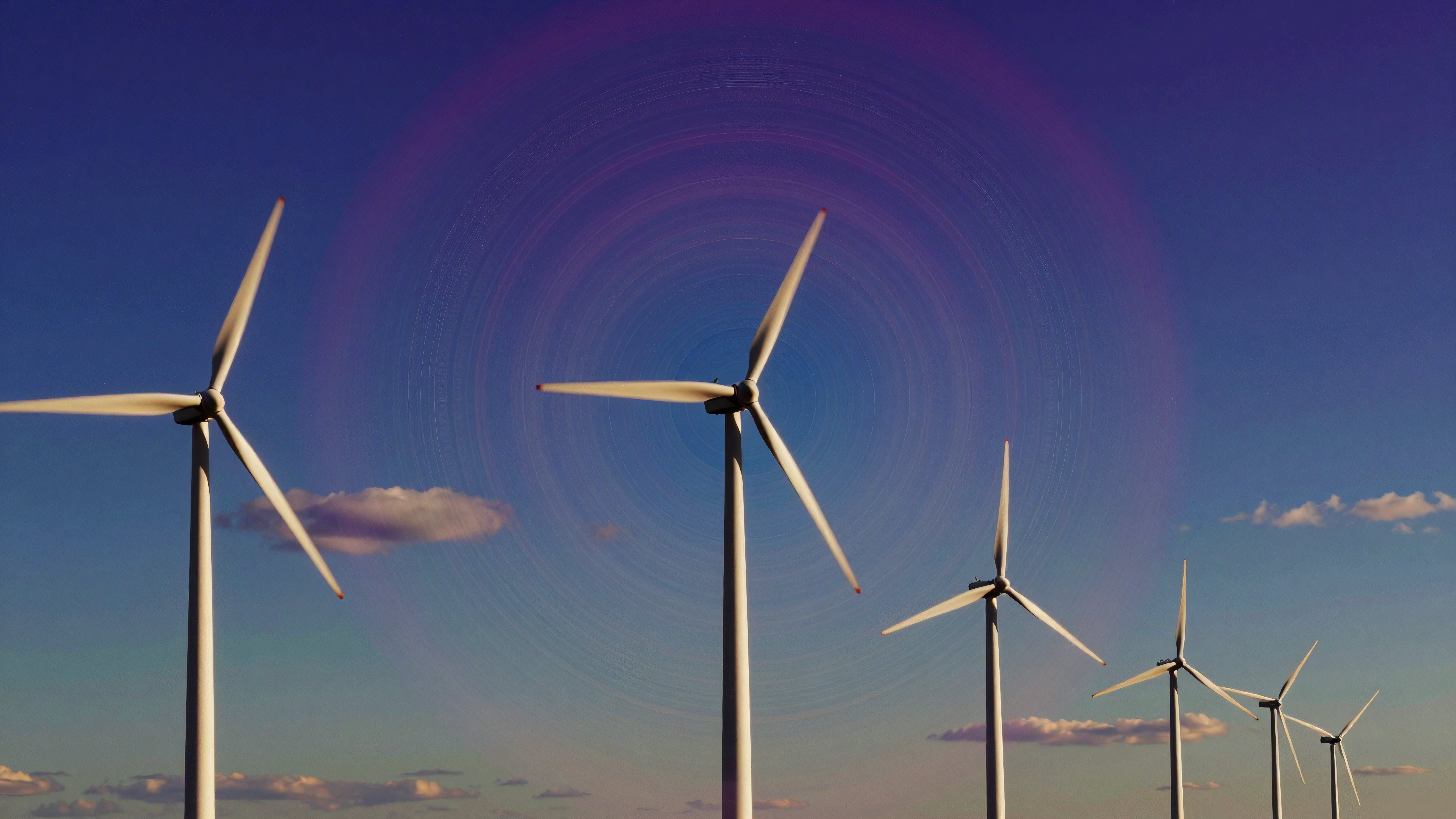 Wind Turbines with Motion Blur Against Blue Sky