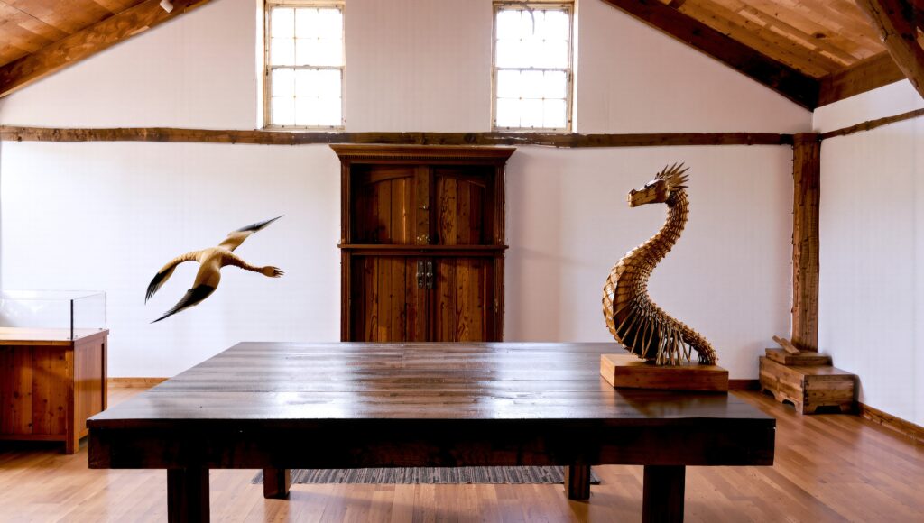 Rustic Attic Room with Wooden Furniture and Sculptural Art