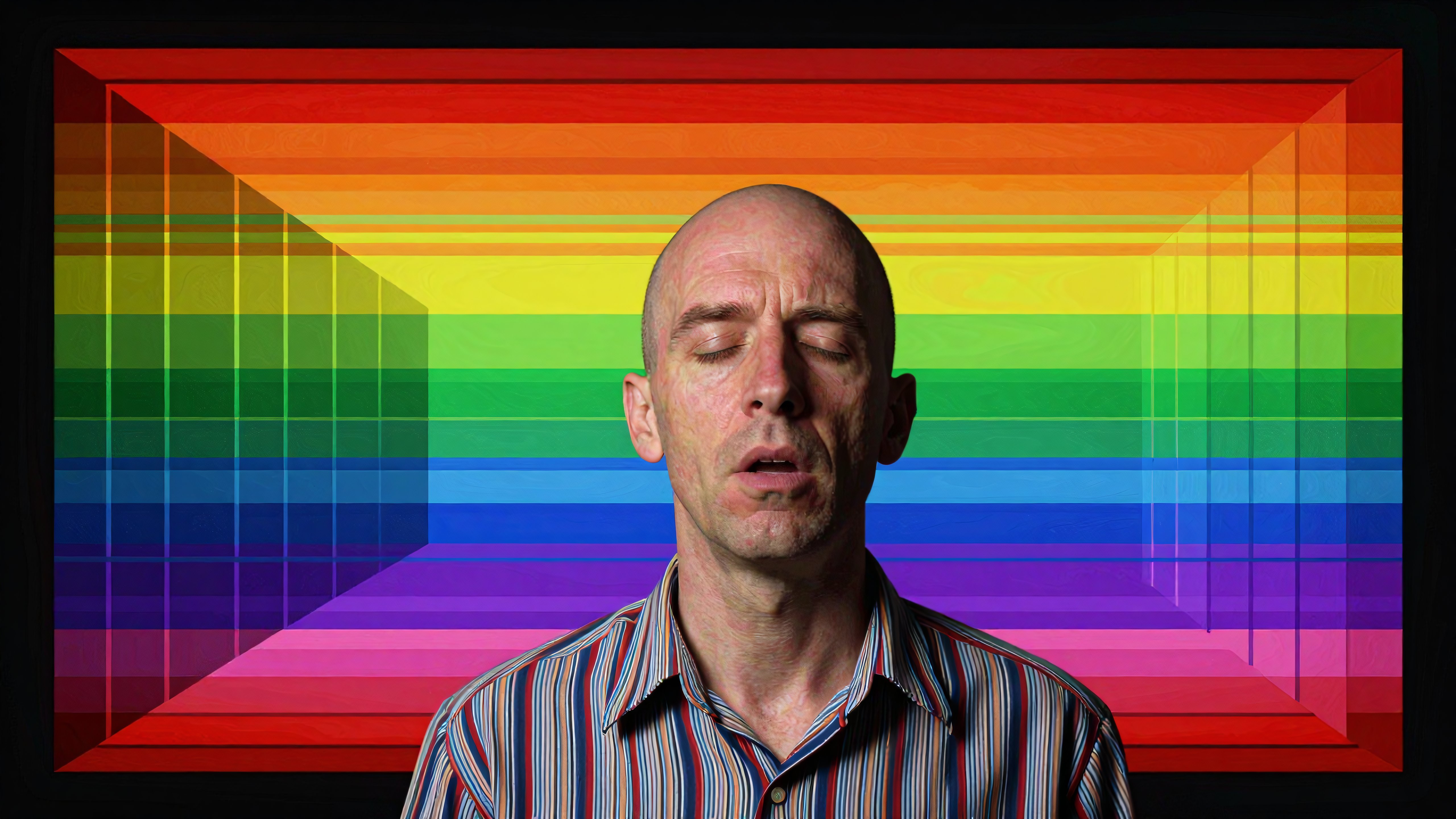 Bald man with closed eyes against vibrant rainbow gradient backdrop