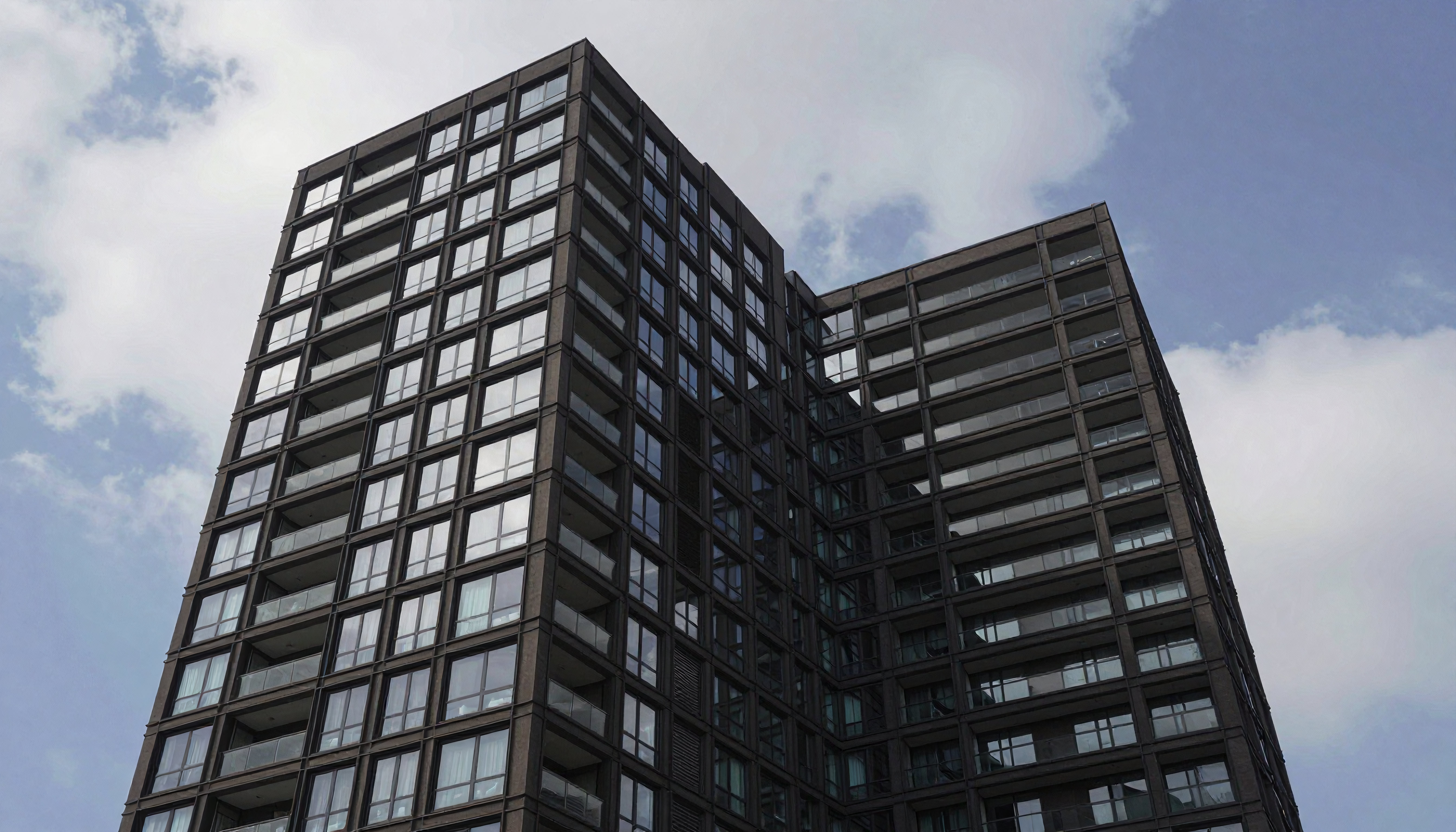 Modern High-Rise Residential Building with Glass Facade and Balconies