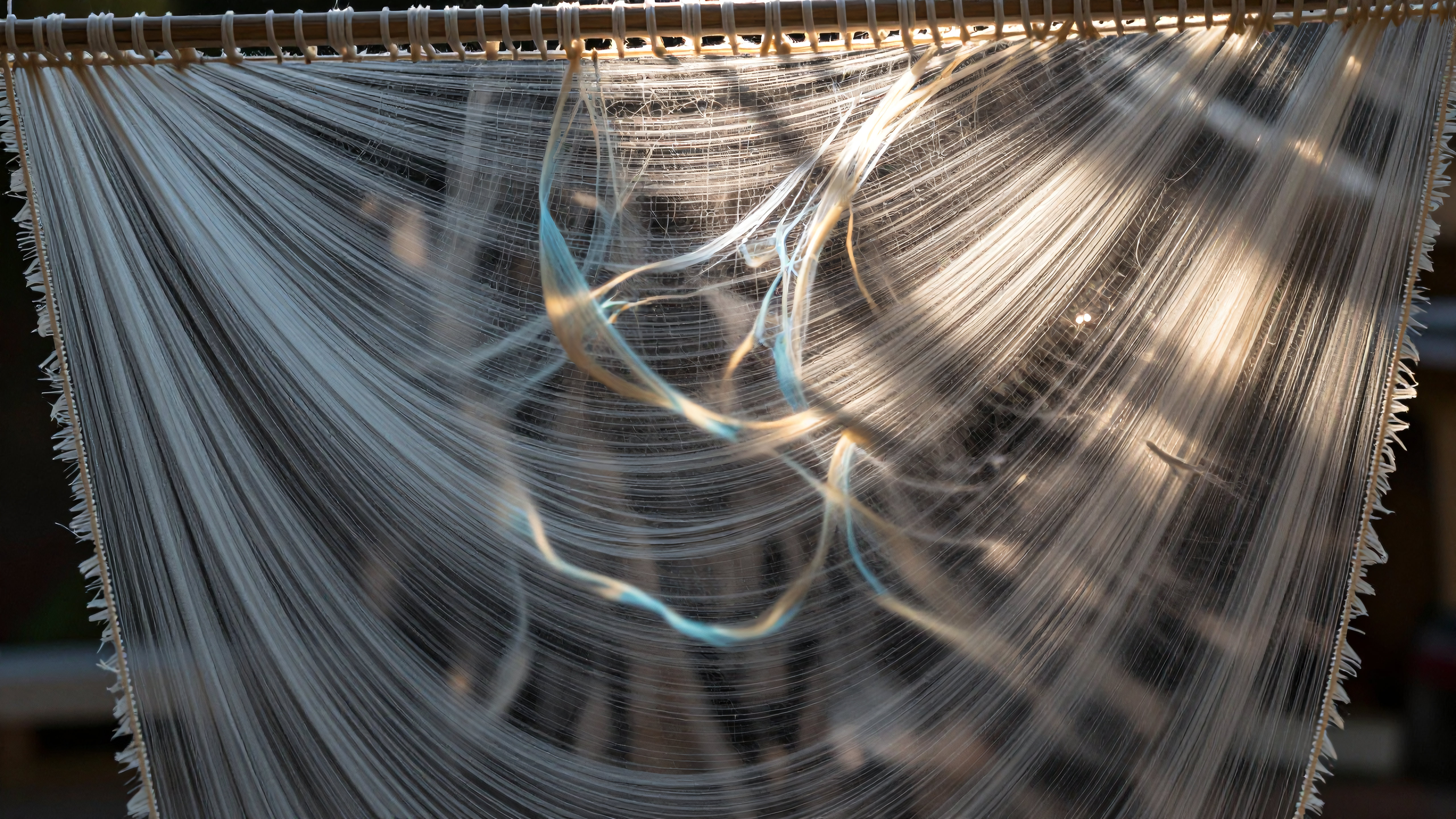 Sunlit Silk Weaving Threads on Traditional Loom