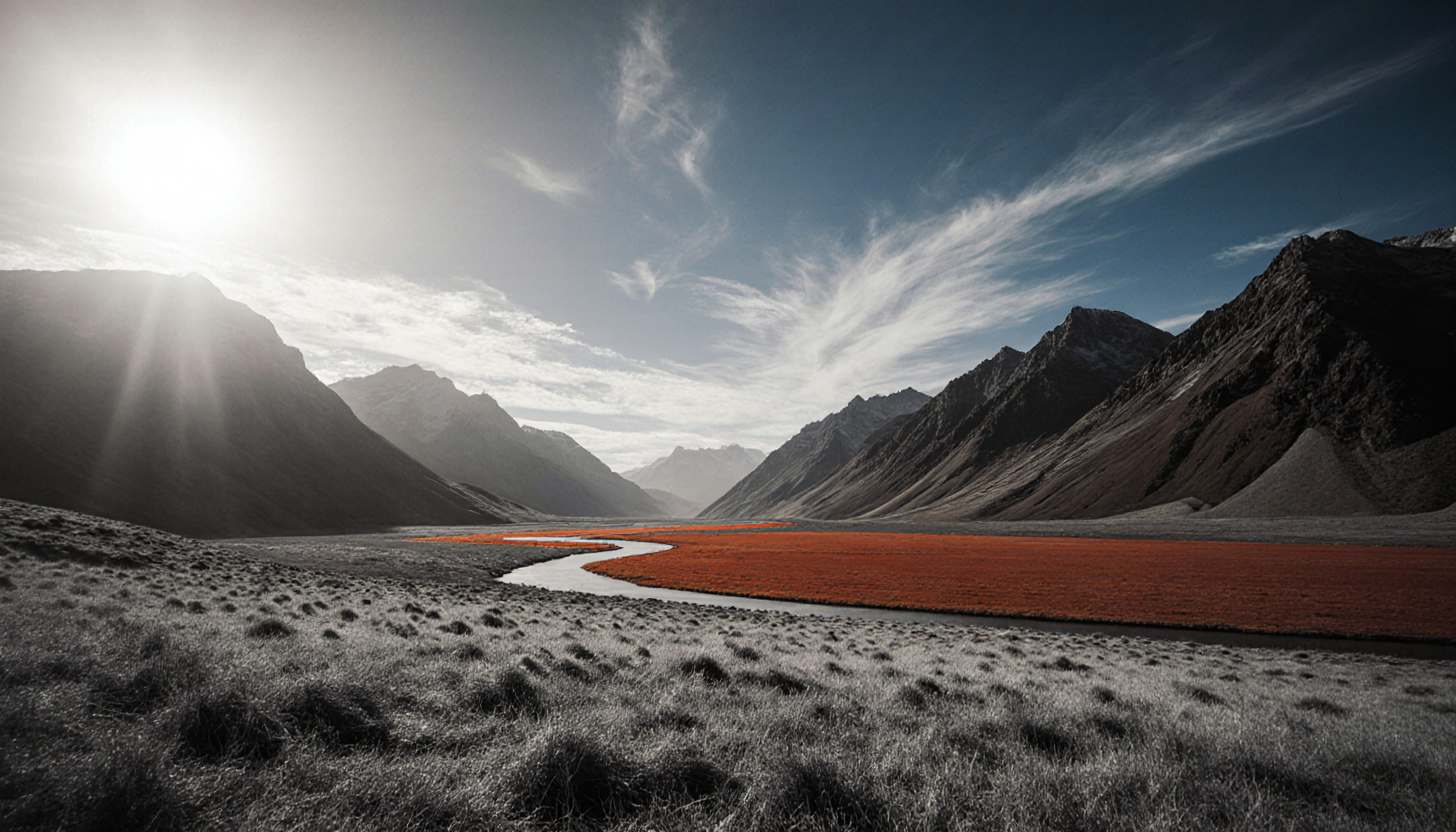 Mountain Valley with Sunlit Peaks and Vibrant Red Flower Field