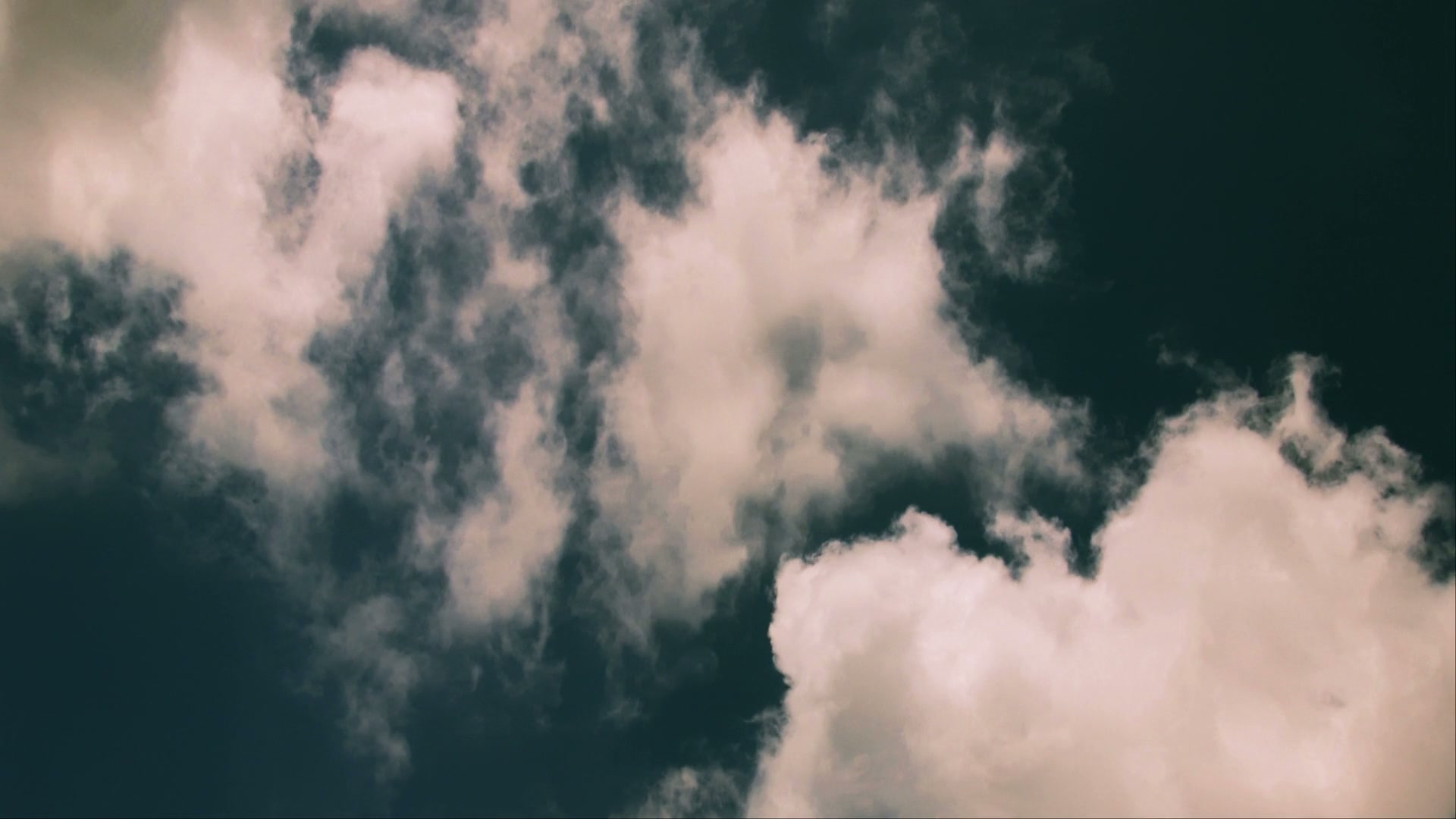 Free HD video of a serene sky filled with fluffy white time-lapse clouds against a deep blue background, capturing a peaceful and tranquil atmosphere.