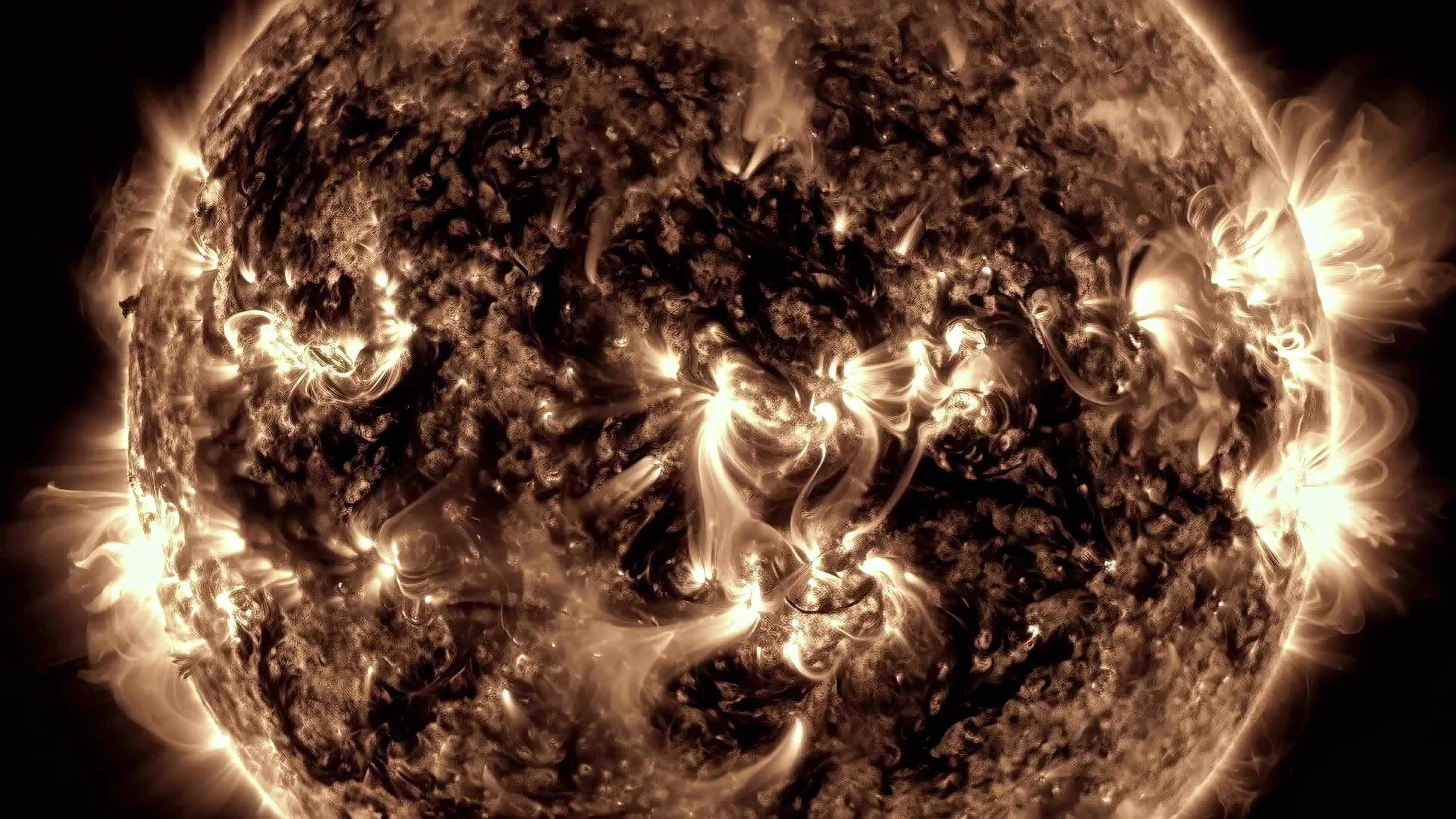 4K Video - Glowing solar storm showcasing dynamic sunspots, flares, and radiant plasma bursts captured from orbit.