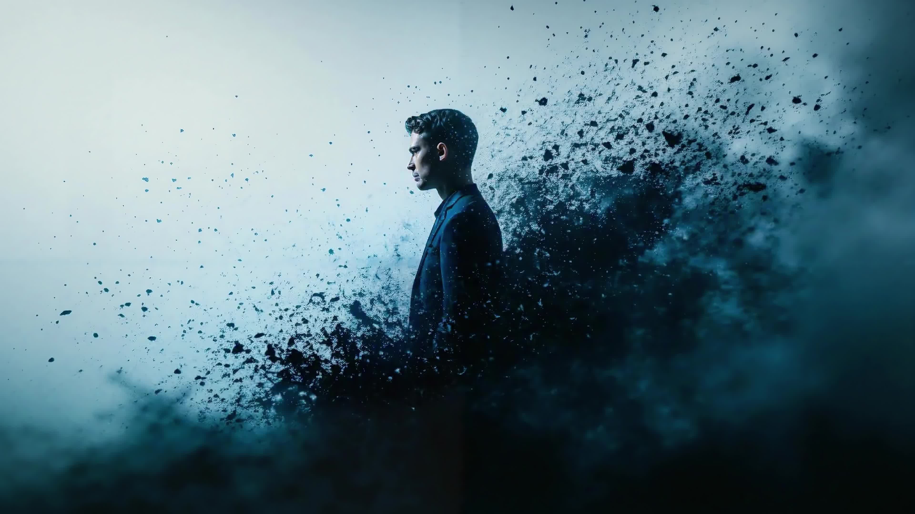 4K Video - Man surrounded by explosive blue smoke with intense atmospheric symbolism and emotional depth.