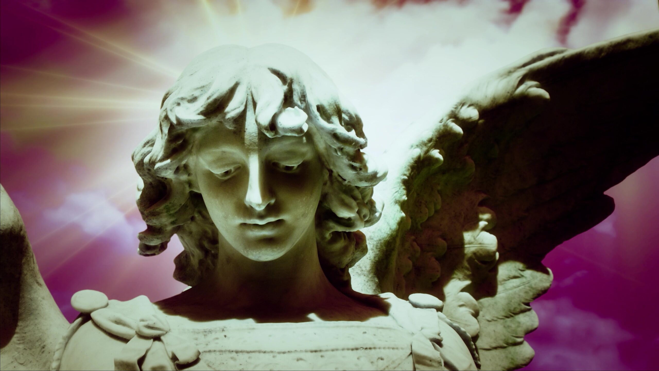 4K video loop of an ethereal angel statue with vibrant wings and glowing time-lapse background.