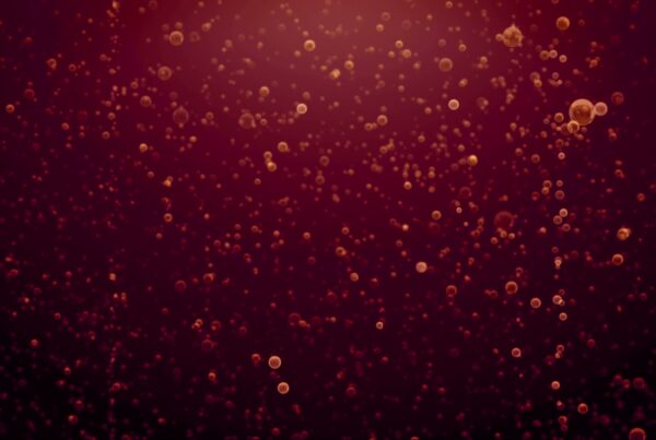 Abstract video loop featuring glowing red bubbles rising against a dark background, creating a dynamic and fluid pattern with a warm and vibrant atmosphere.