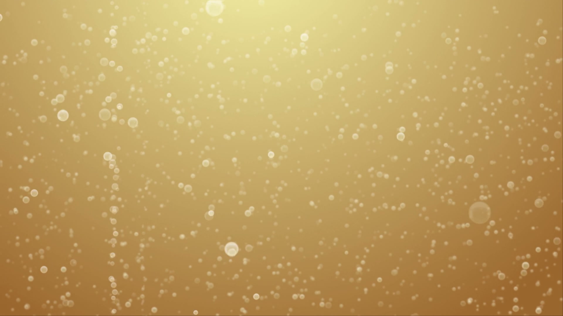 Dreamy golden background with delicate bokeh champaign bubbles rising, creating an elegant and sophisticated atmosphere of celebration.