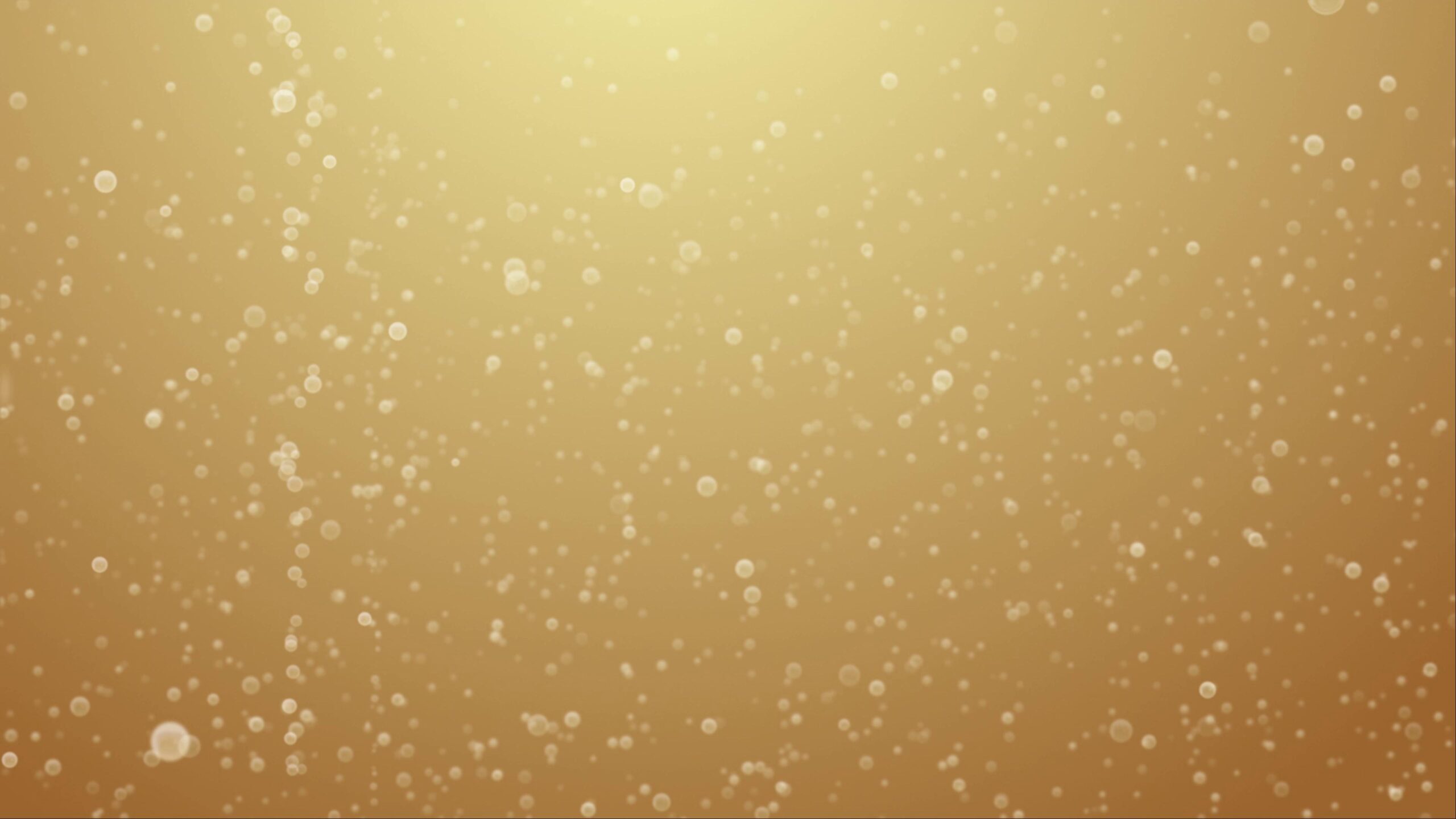 4K video loop of golden bubbles rising against warm gradient background with gentle movement and radiant glow.