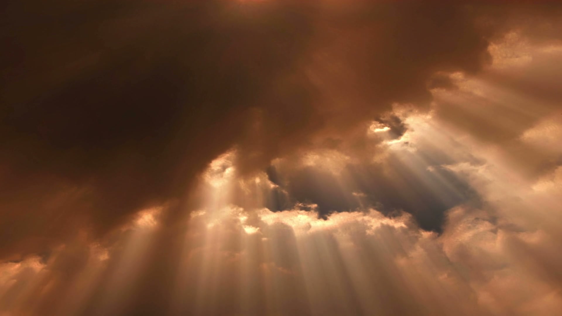 A sky dominated by dark, dense clouds with shafts of light piercing through the gaps in the clouds, video loop.