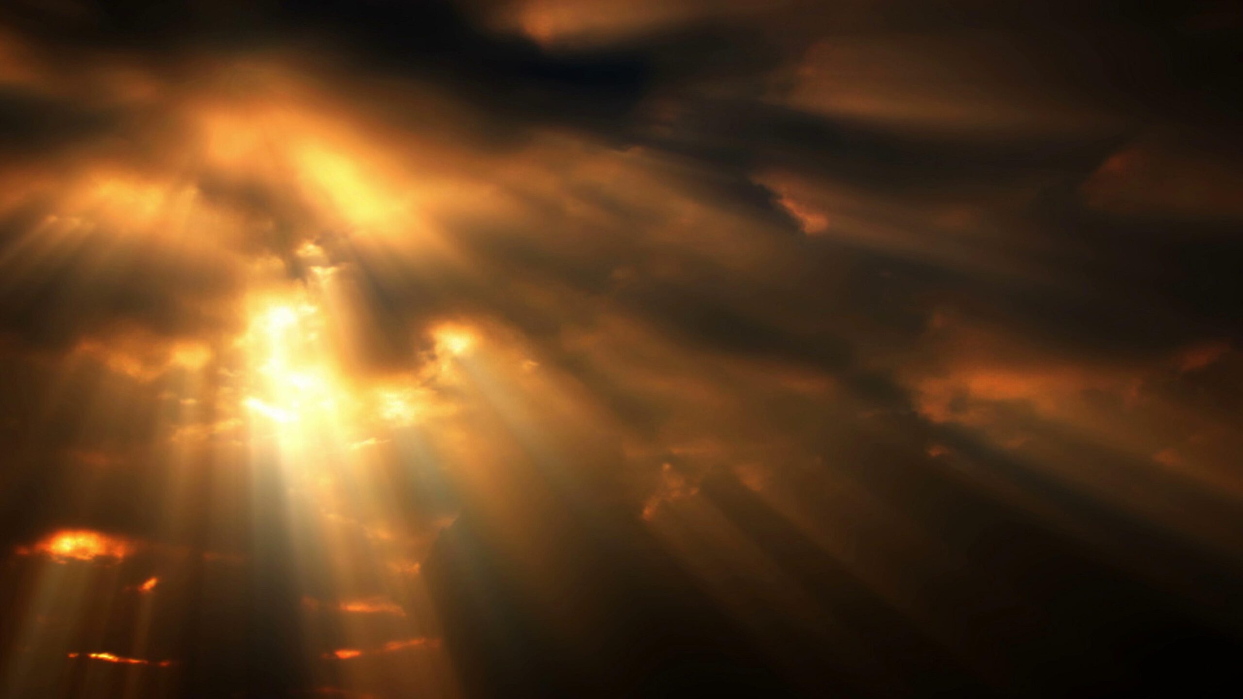 Dramatic 4K video orange-hued sunshine slices through turbulent clouds above earthbound landscapes, casting long shadows and illuminating distant horizons.