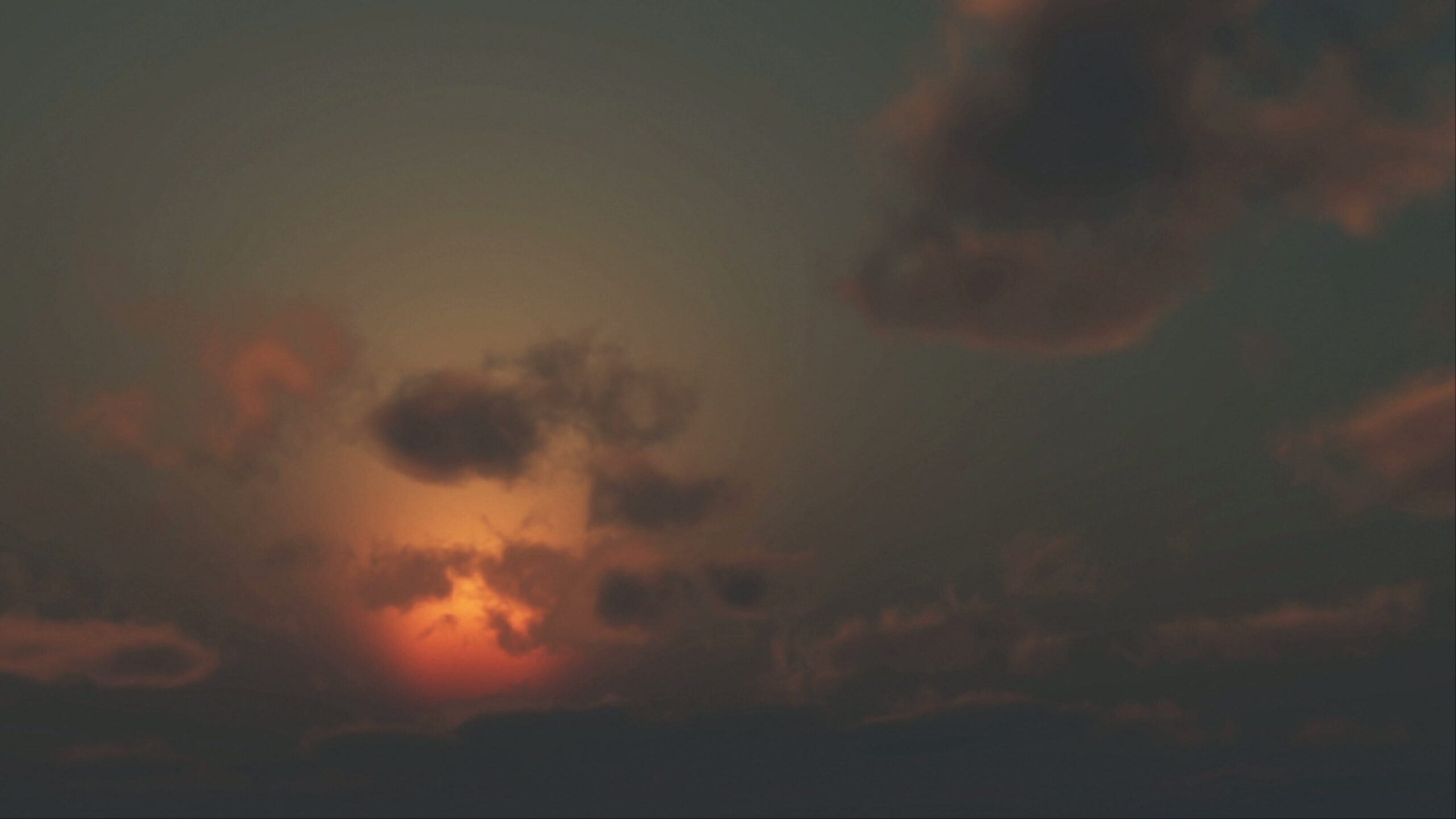 Beautiful sunset animation with dark clouds against an evening sky.