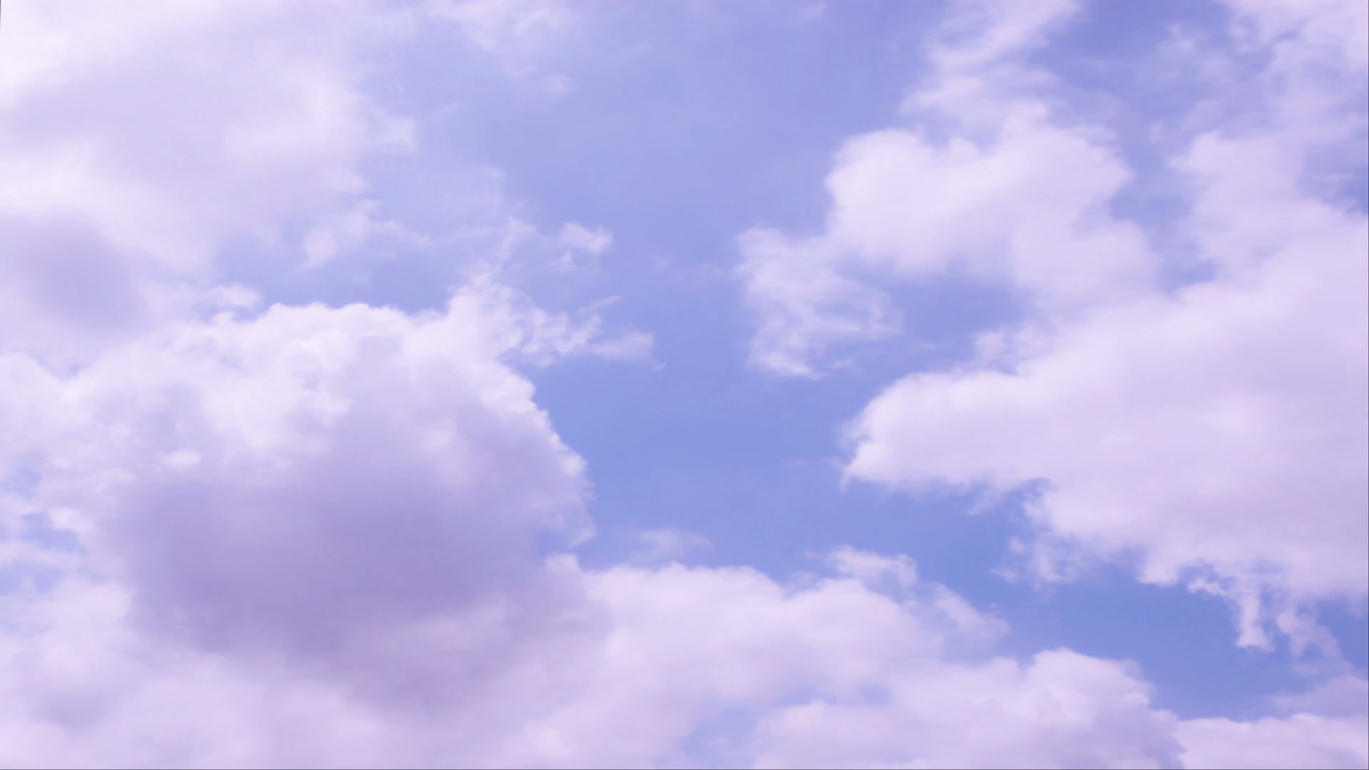 A serene sky scene featuring fluffy white time-lapse clouds with a soft purple hue set against a bright blue sky, creating a tranquil and peaceful atmosphere.