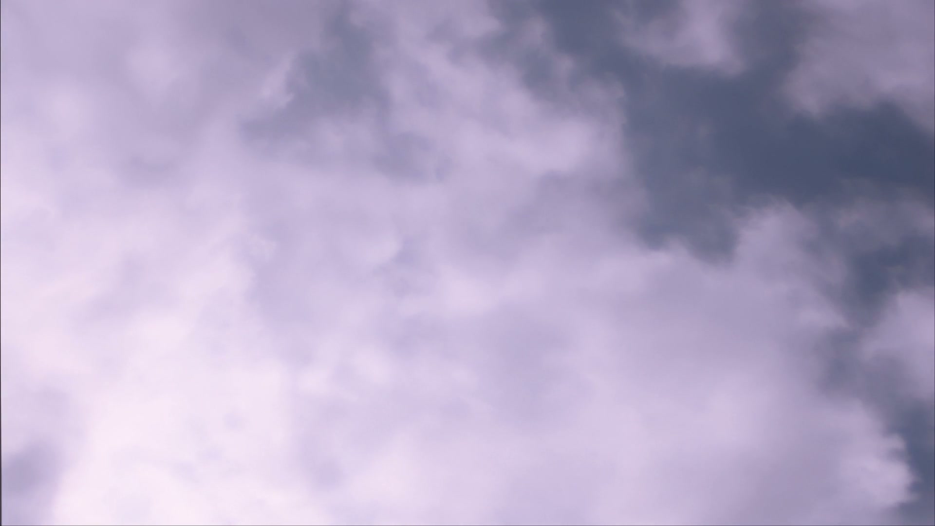 Serene sky filled with soft time-lapse clouds.