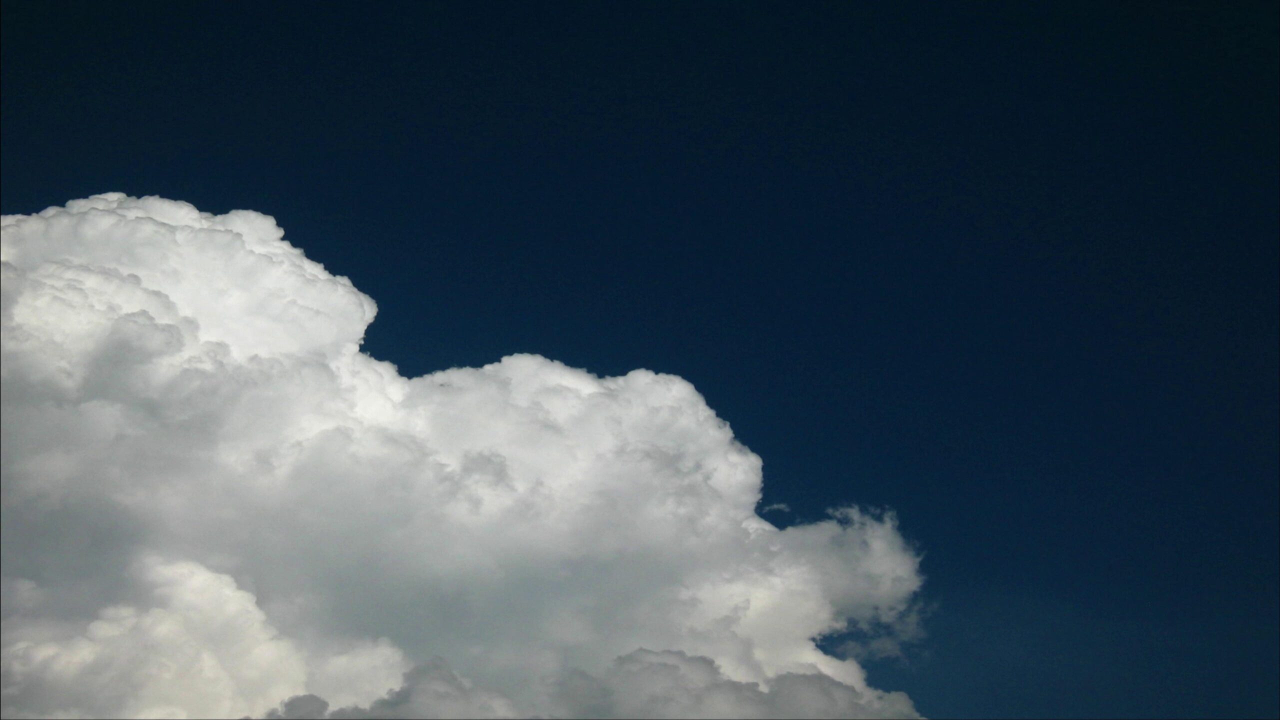 4K time-lapse clouds moving dynamically under deep blue sky.