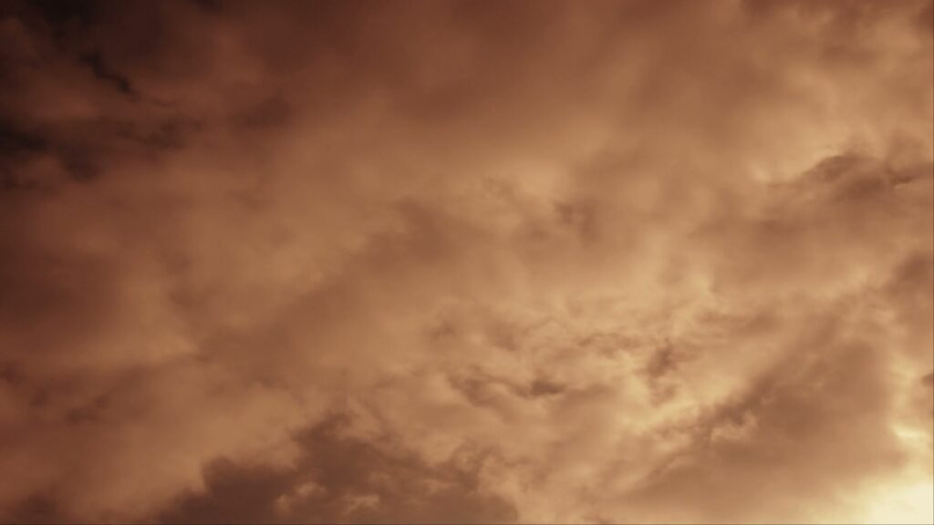 HD video of a dramatic time-lapse cloudy sky at sunset, showcasing swirling cloud formations and dynamic lighting.