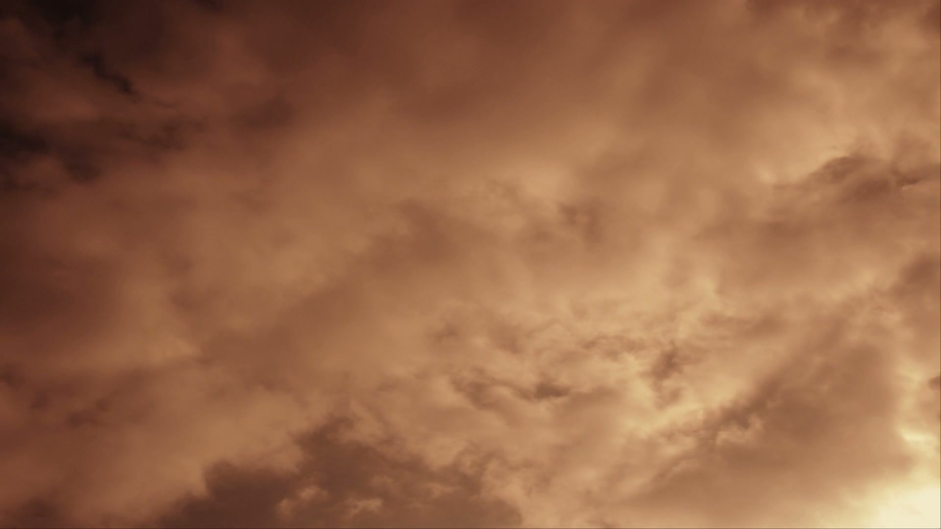 HD video of a dramatic time-lapse cloudy sky at sunset, showcasing swirling cloud formations and dynamic lighting.