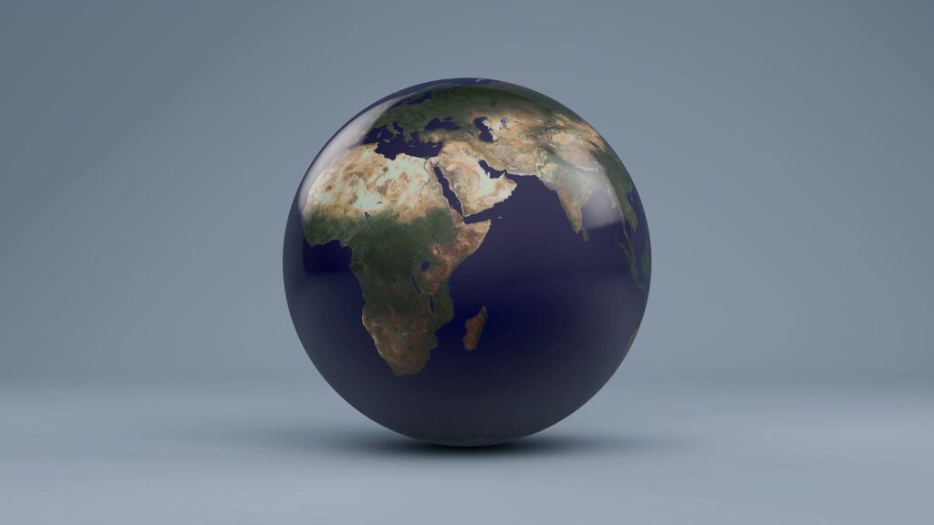 High-resolution rotating earth model with realistic textures and shadows set against soft gray-blue backdrop.