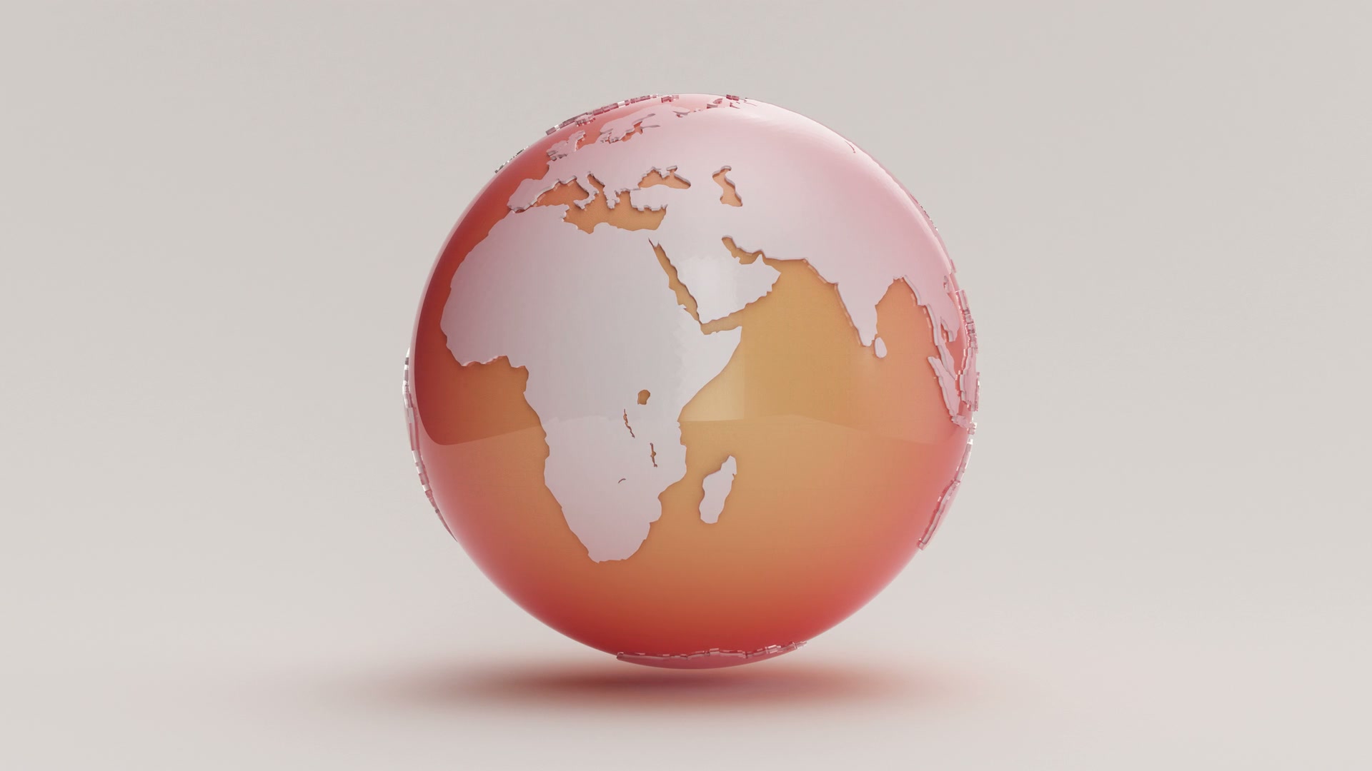 A 3D globe animation loop with continents in a gradient from red to orange on a plain background.