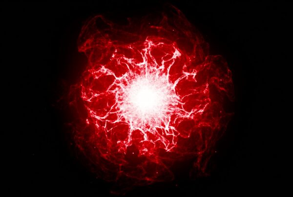 Abstract video loop of a cosmic explosion, with vibrant red energy bursts against a black backdrop and swirling patterns and bright white center.