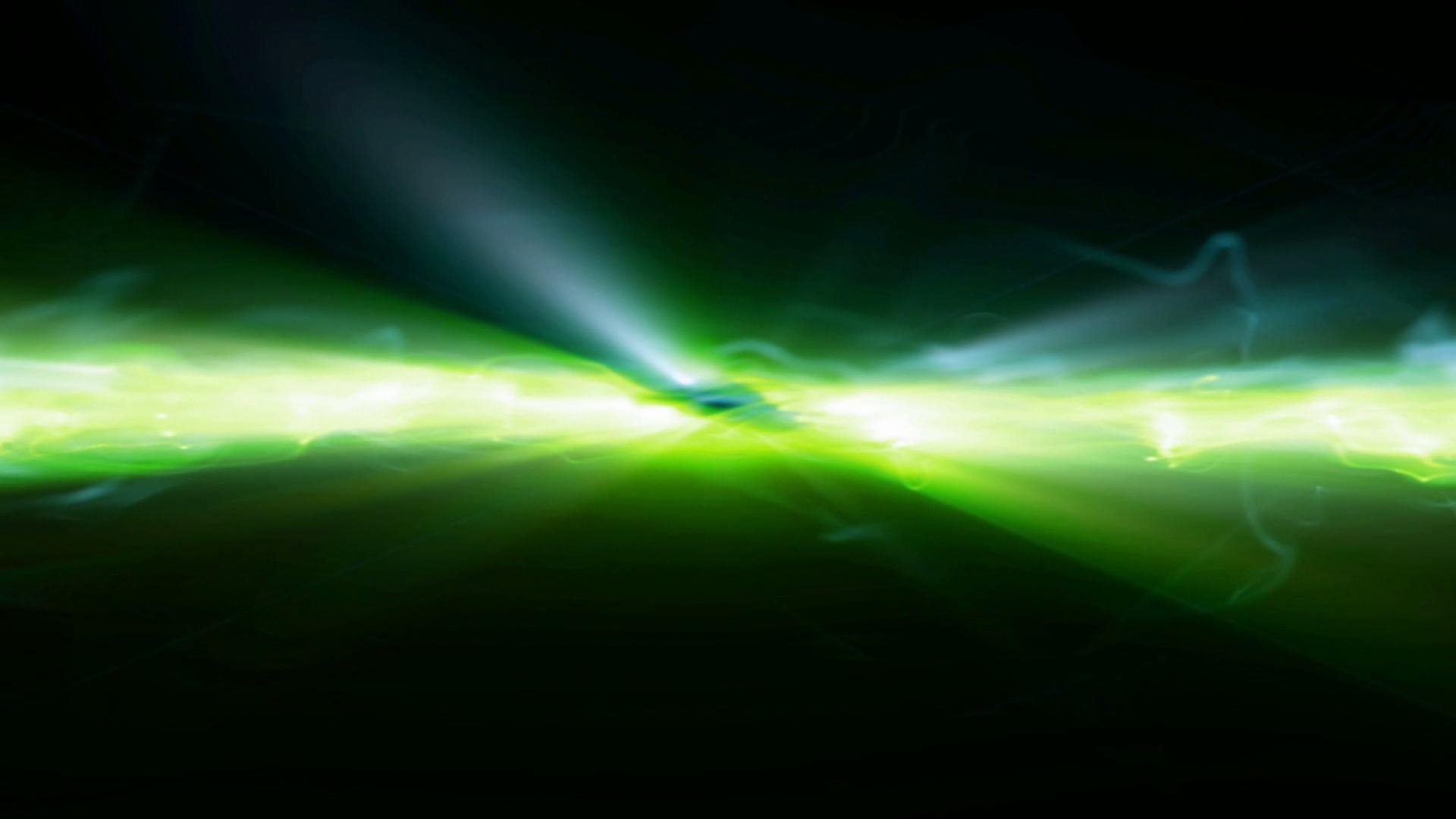 Abstract HD video loop of vibrant green and yellow light streaks bursting outward, creating dynamic energy in a dark, cosmic video background.