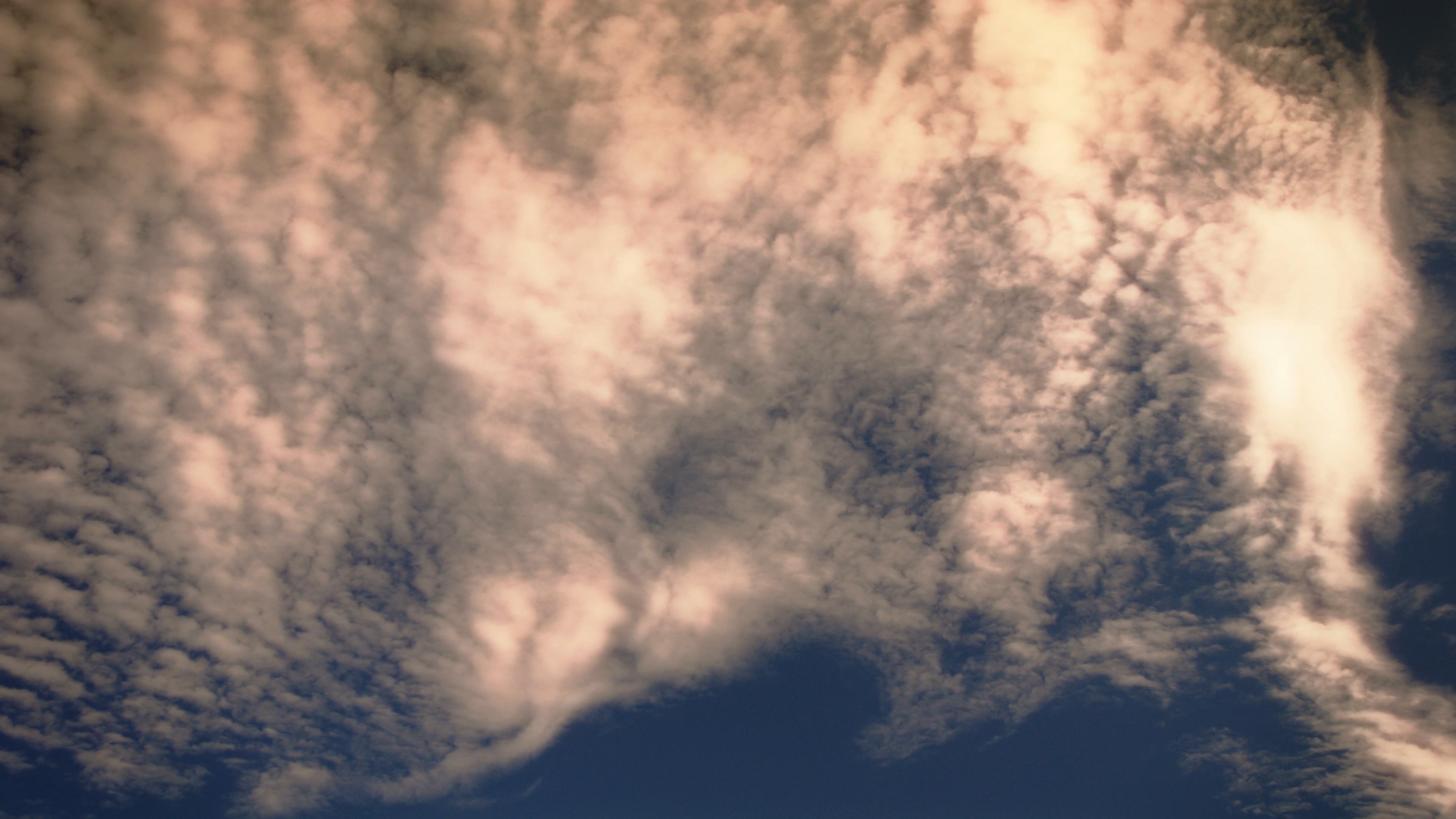 Clouds drift over calming twilight sky