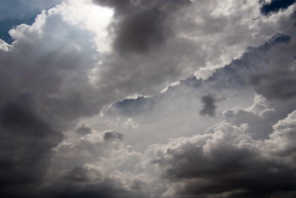 Dramatic shifting storm clouds overhead during sunset transitions.