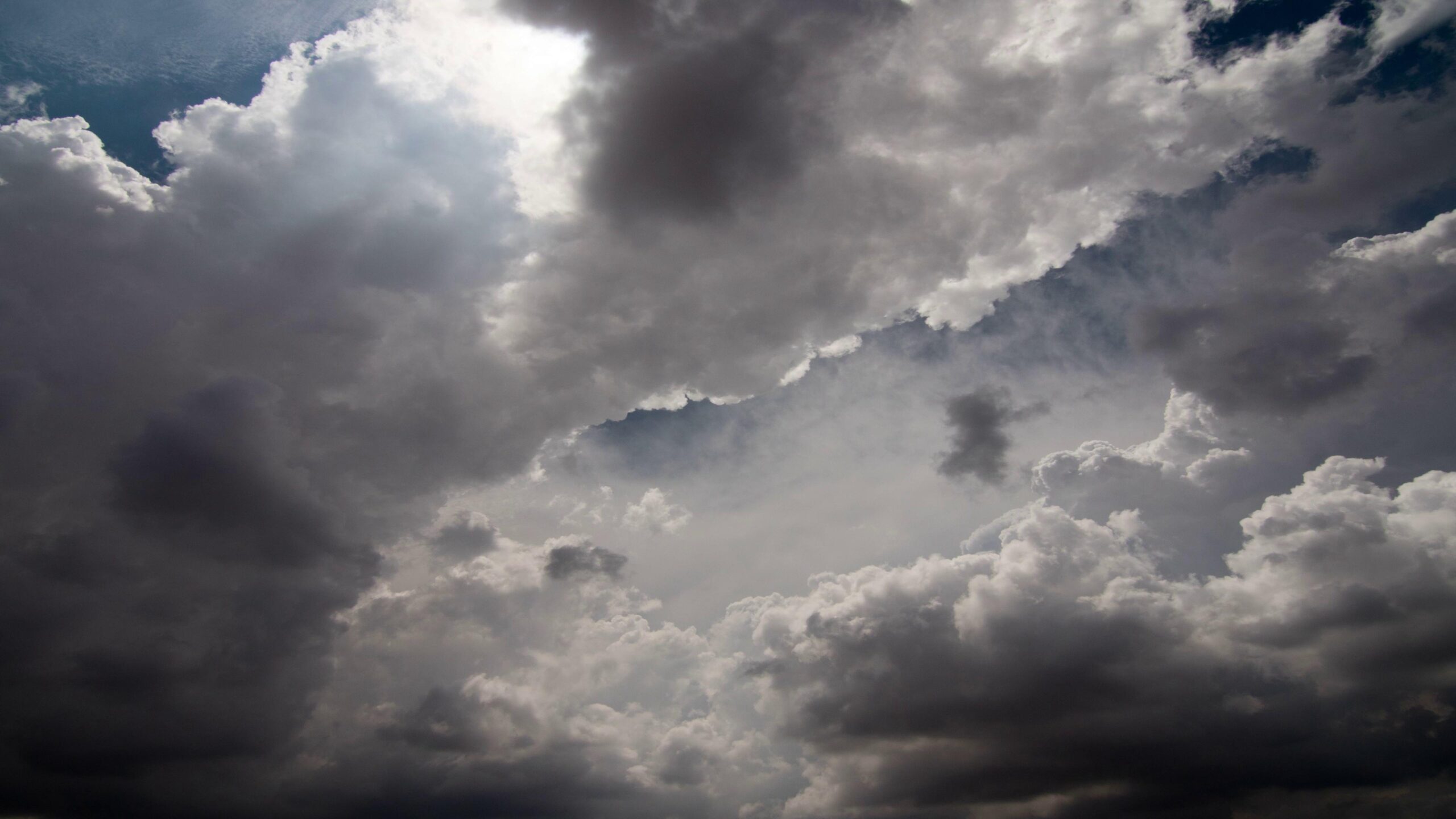 Dramatic shifting storm clouds overhead during sunset transitions.