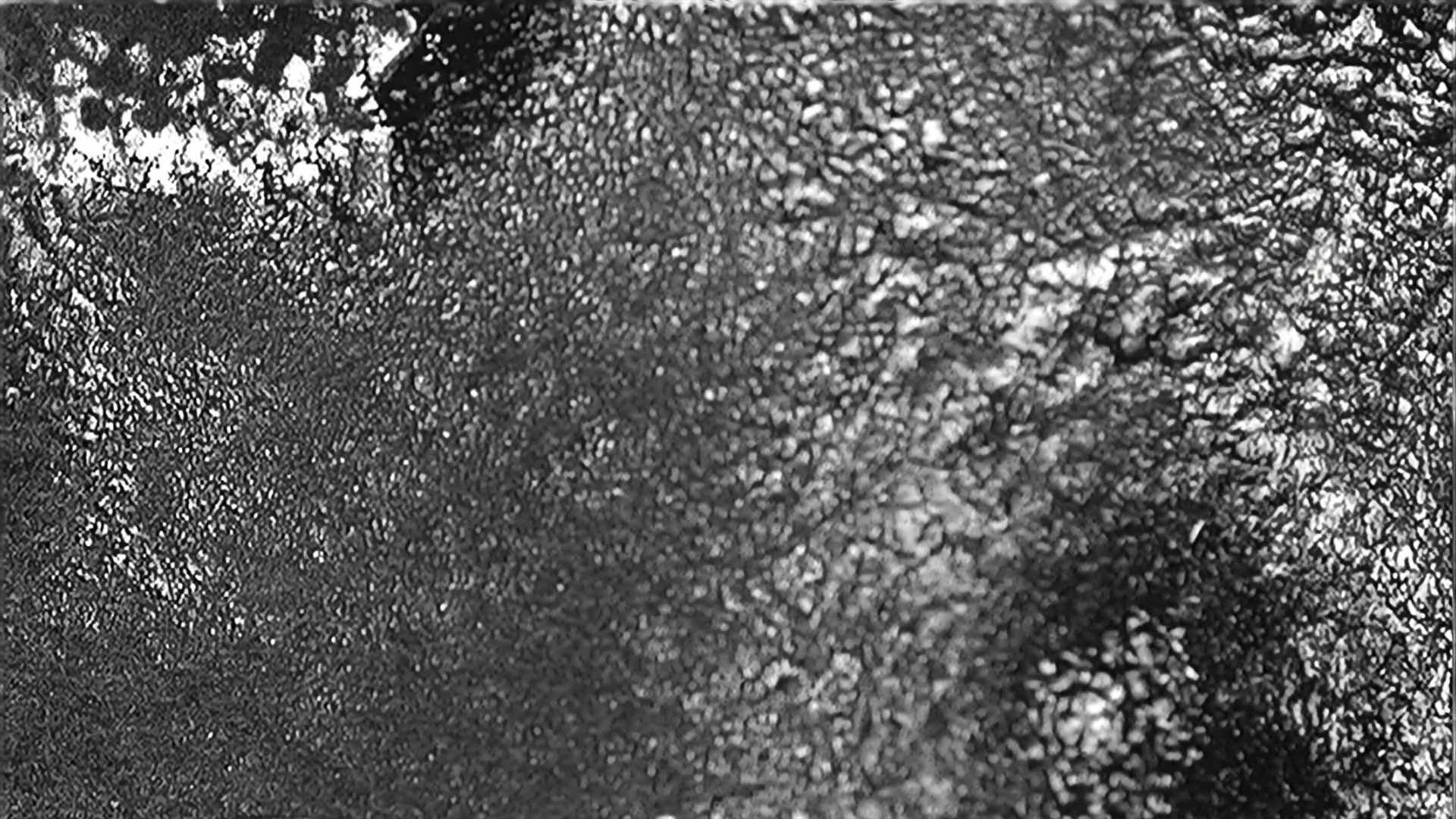 A high-contrast black and white abstract video animation featuring flickering film damage.