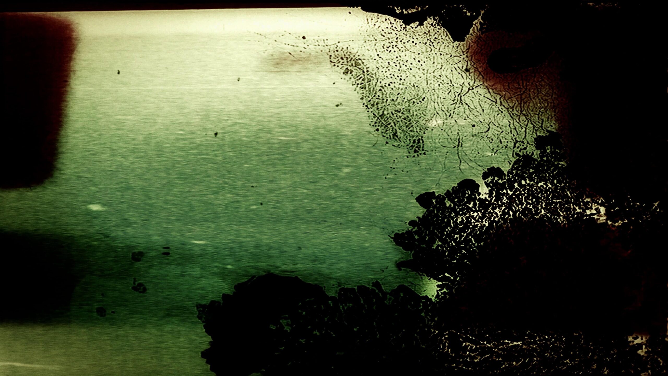 4K video loop of distorted vintage film damage with eerie glow and crackled surfaces.
