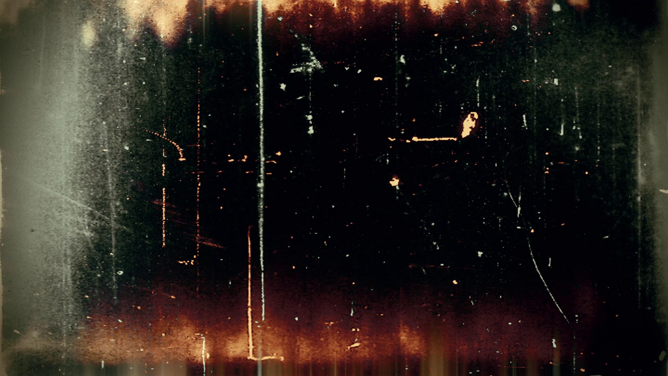 4K video loop of grainy retro 16mm film leader with glowing artifacts and vertical scratch effects.