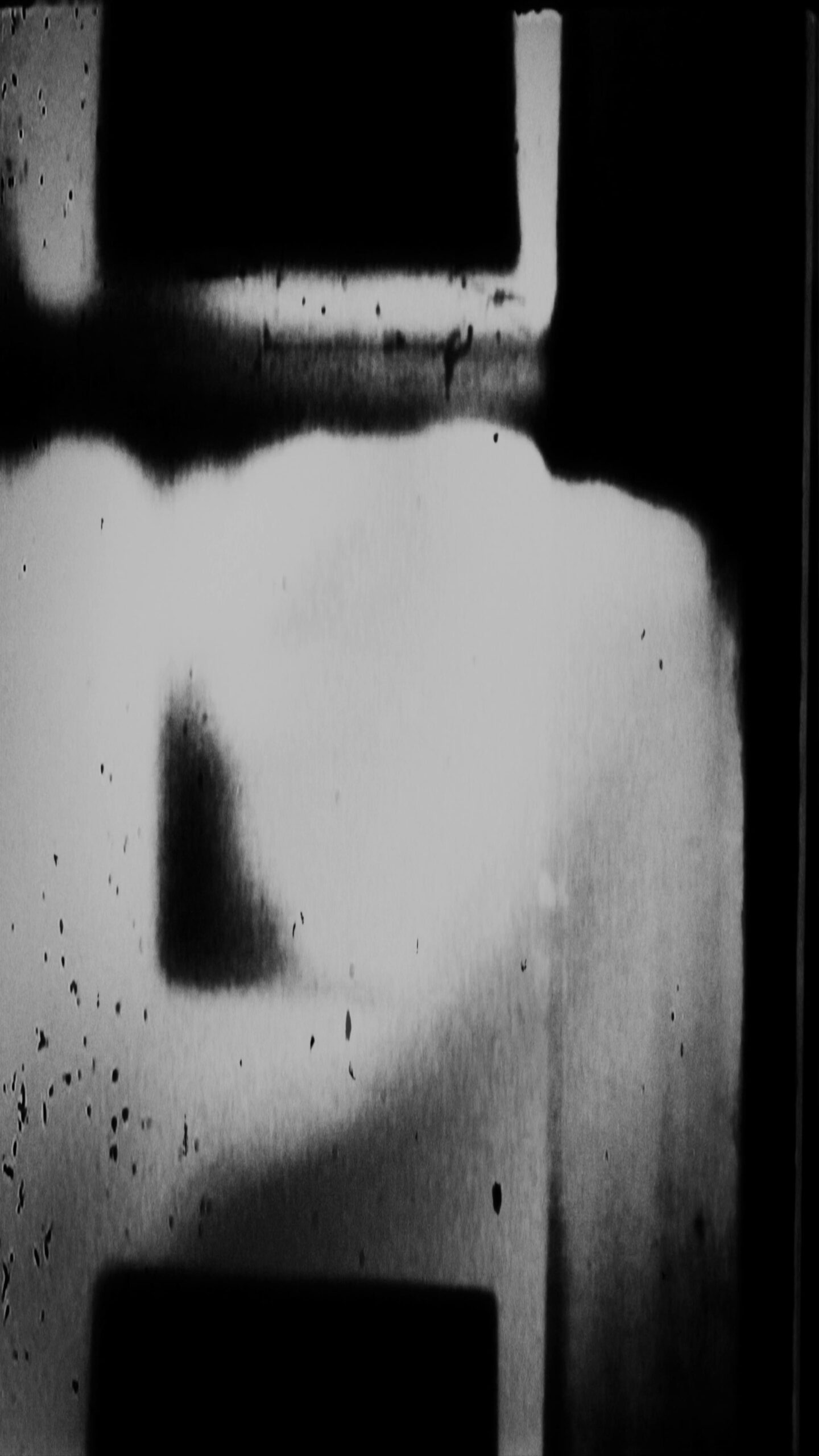 4K vertical video loop of black-and-white 16mm film leader with shadows and texture artifacts.