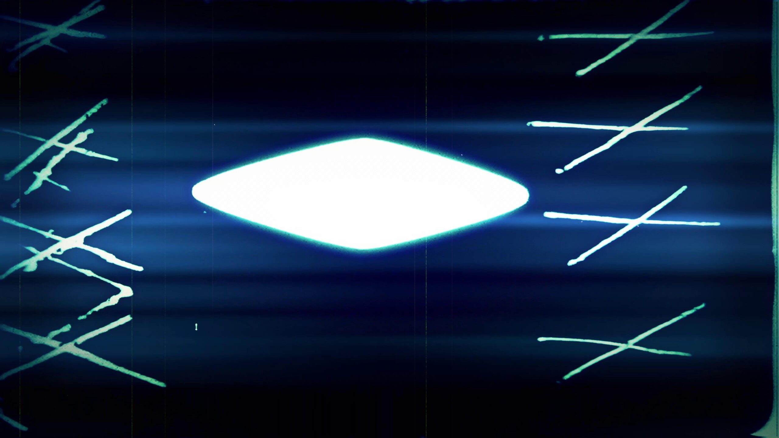 4K video of abstract 16mm film leader with grainy textures and fading colors.