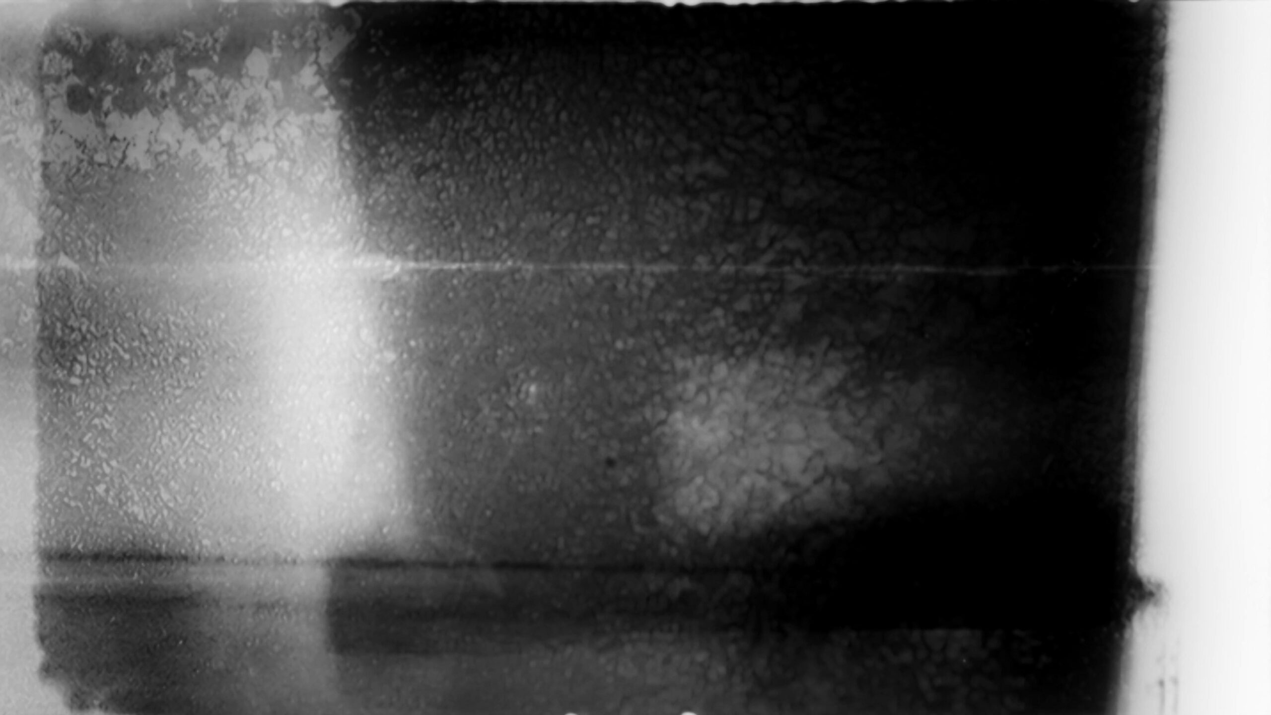 4K video loop of vintage 16mm film leader with textured patterns and grayscale abstraction.