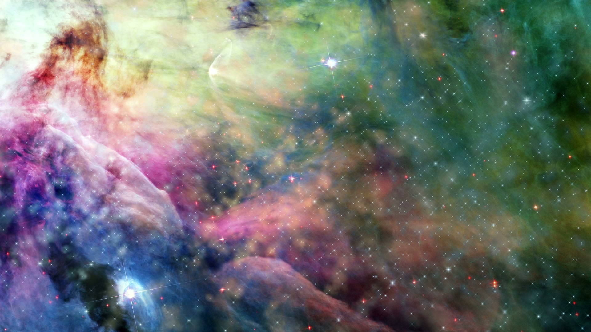 A vibrant video animation of a nebula in deep space, showcasing swirling clouds of gas and dust in pink, blue, green, and orange hues with scattered bright stars emitting a radiant glow.