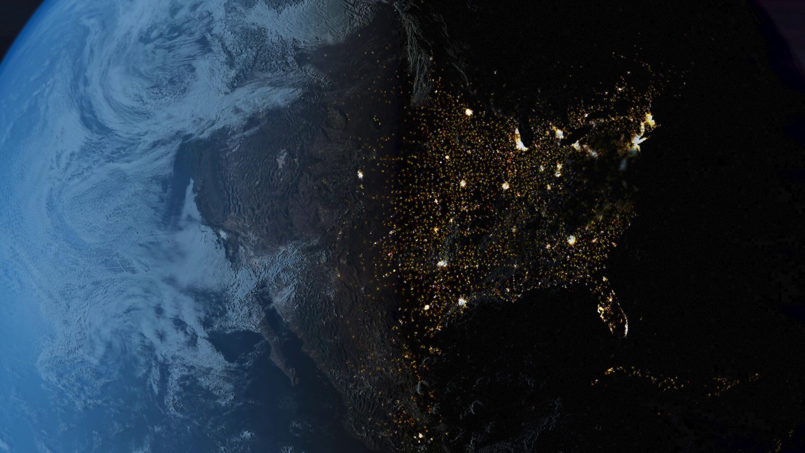 A night view of Earth from space showing illuminated urban areas and the transition from day to night.
