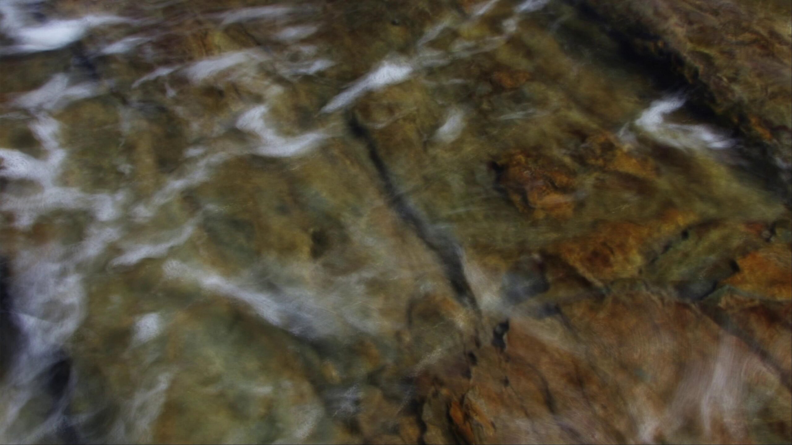 Clear stream flows over rocky riverbed