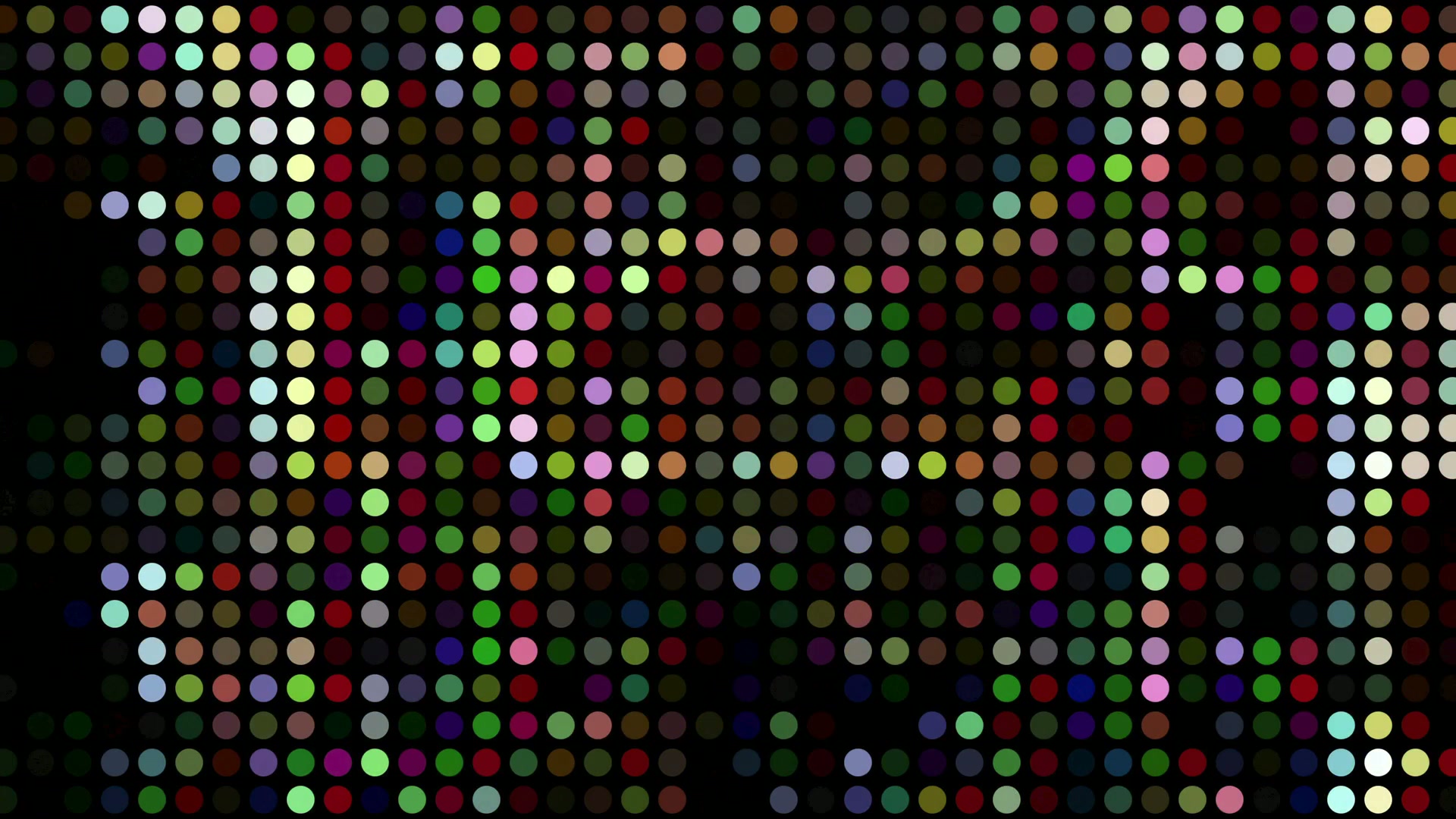 Vibrant multicolored dot matrix video loop on a black background, featuring a grid of uniform circles in random animating colors such as red, blue, and green, creating a pixelated and abstract digital art effect.