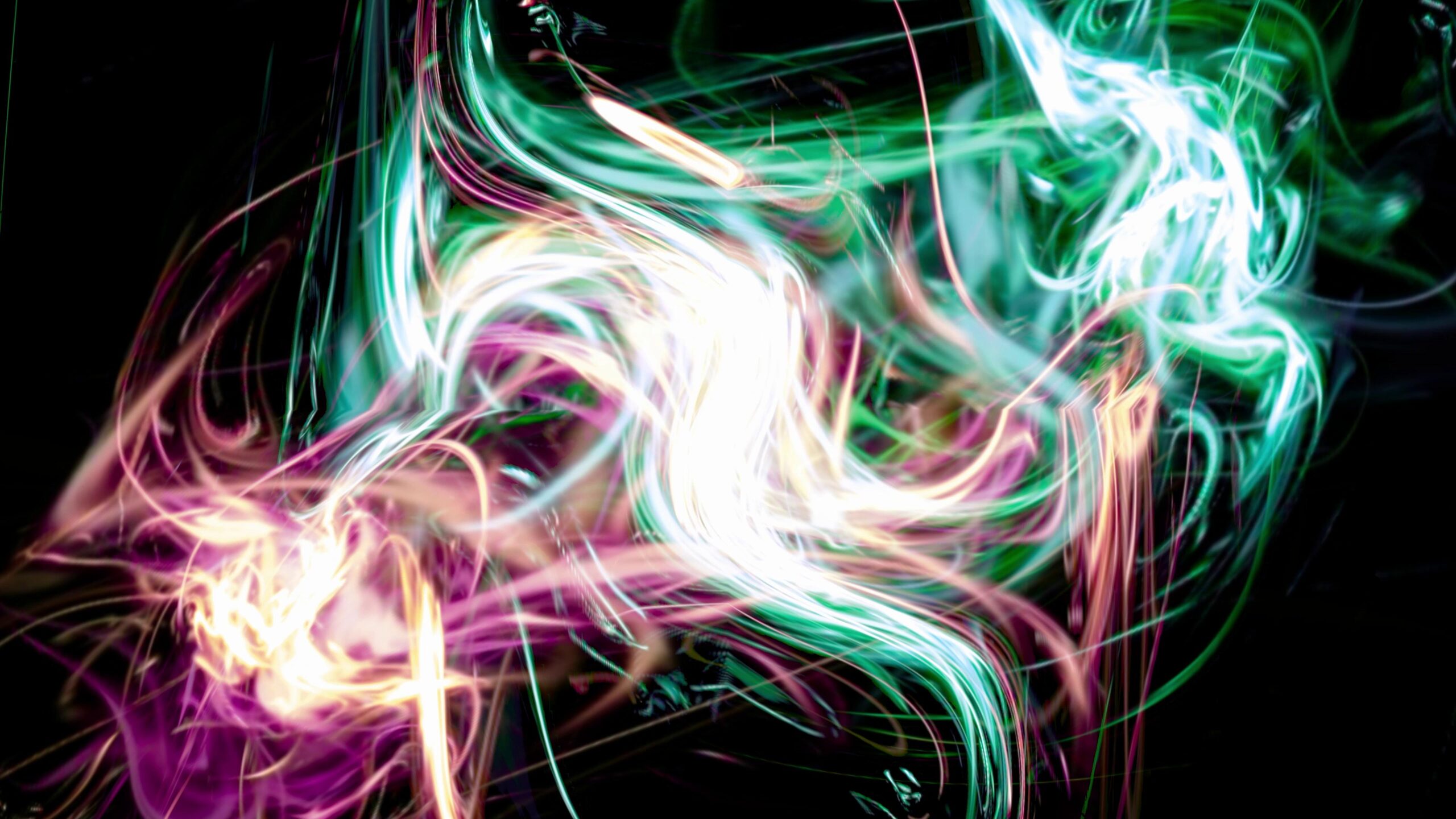 Neon streaks swirl dynamically against black video background creating vibrant, ethereal motion.