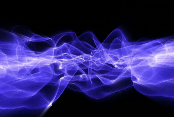 Abstract video loop animation featuring luminous purple and blue flowing lines against a black background, creating a dynamic and ethereal display of light and energy.