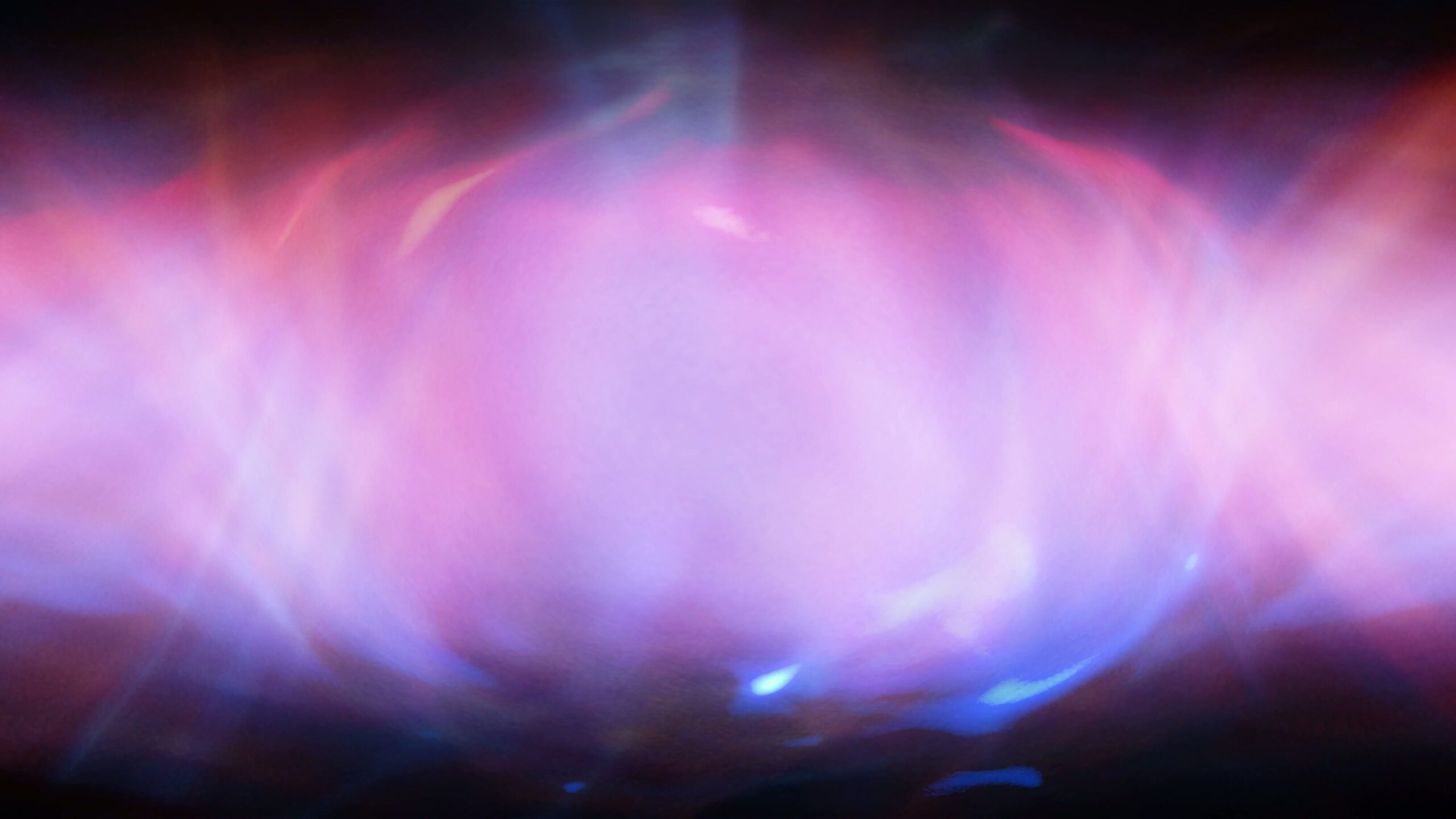An abstract 4K video loop of glowing pink and purple light with cosmic and ethereal patterns.