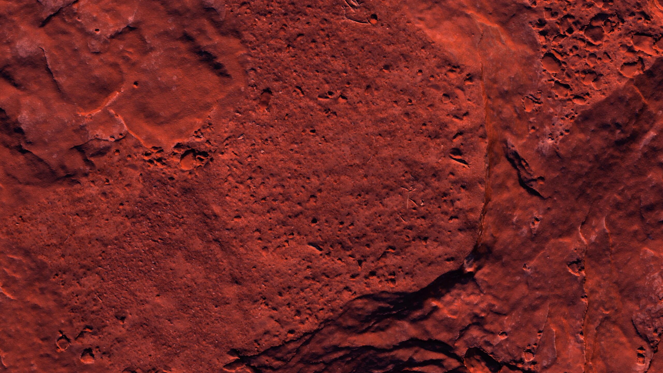 Mars' cratered reddish-brown rocky surface seen from space.