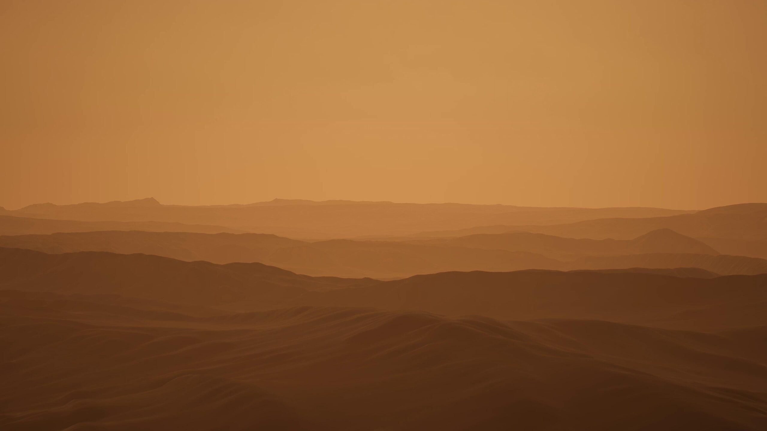 Serene Martian desert with rolling dunes under golden-orange twilight sky.