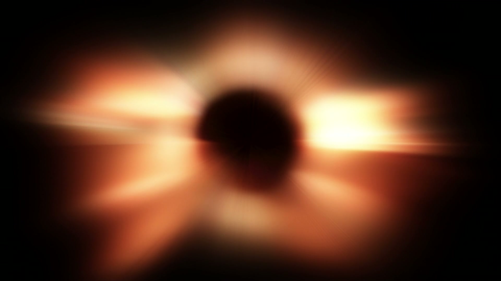 Abstract video loop featuring fiery orange and yellow light radiating from a dark central circle, resembling a celestial event or eclipse, with smooth transitions into a dark background.