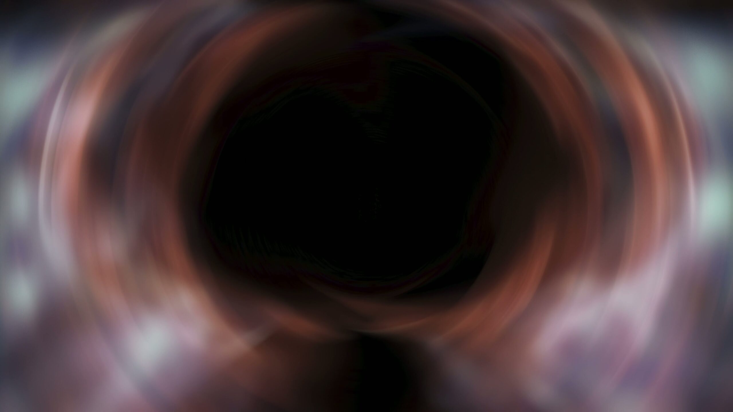 Abstract swirling vortex with dark center surrounded by vibrant colors resembling a cosmic whirlpool.