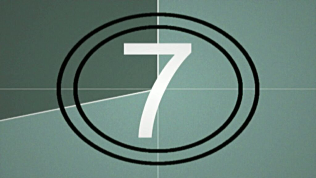 Classic vintage film countdown with the numbers in white surrounded by concentric circles on a textured green background.
