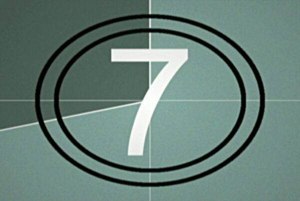 Classic vintage film countdown with the numbers in white surrounded by concentric circles on a textured green background.