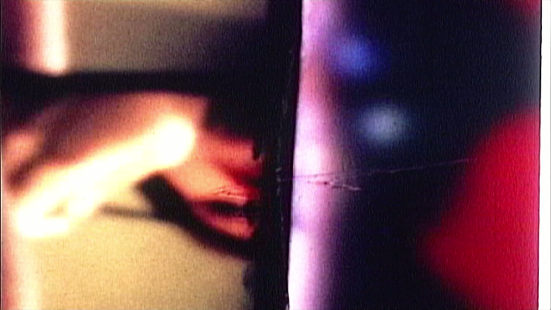 Abstract video loop of film leader with blurred colors and grainy textures creating a dynamic, vintage-style animation.