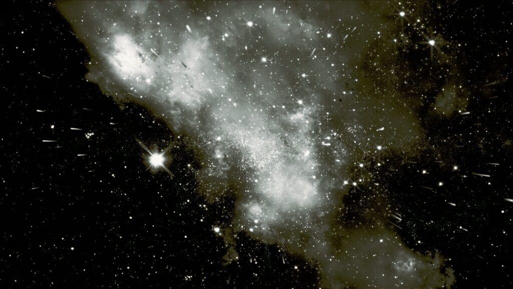 A breathtaking video loop of outer space filled with shimmering stars and a glowing nebula, showcasing the ethereal beauty of the cosmos in a vast and mysterious starfield.